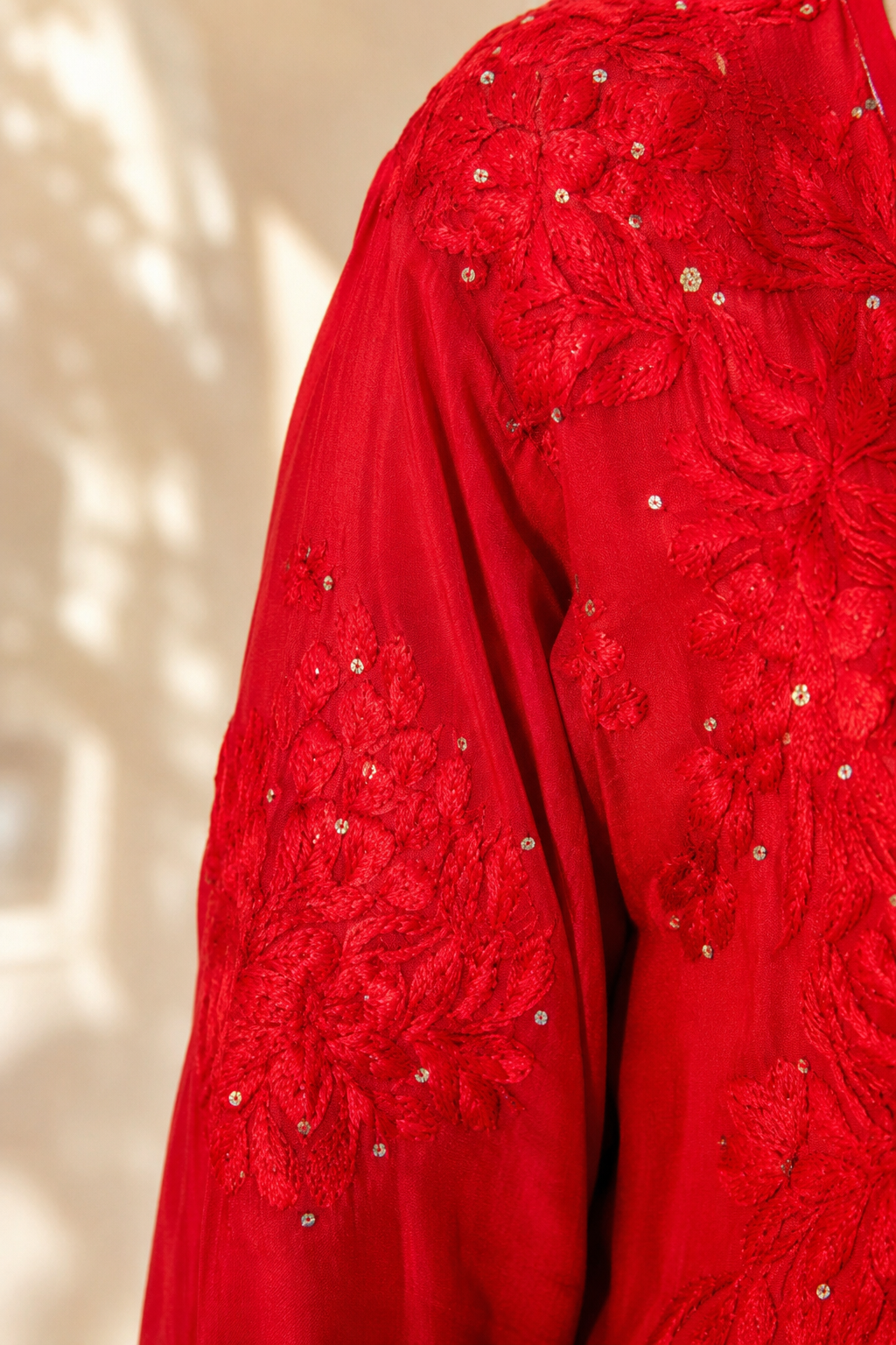 Red embroidered garment on a beige background