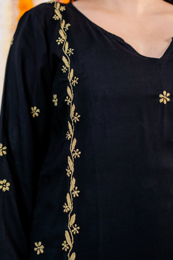 Black garment with gold embroidery details